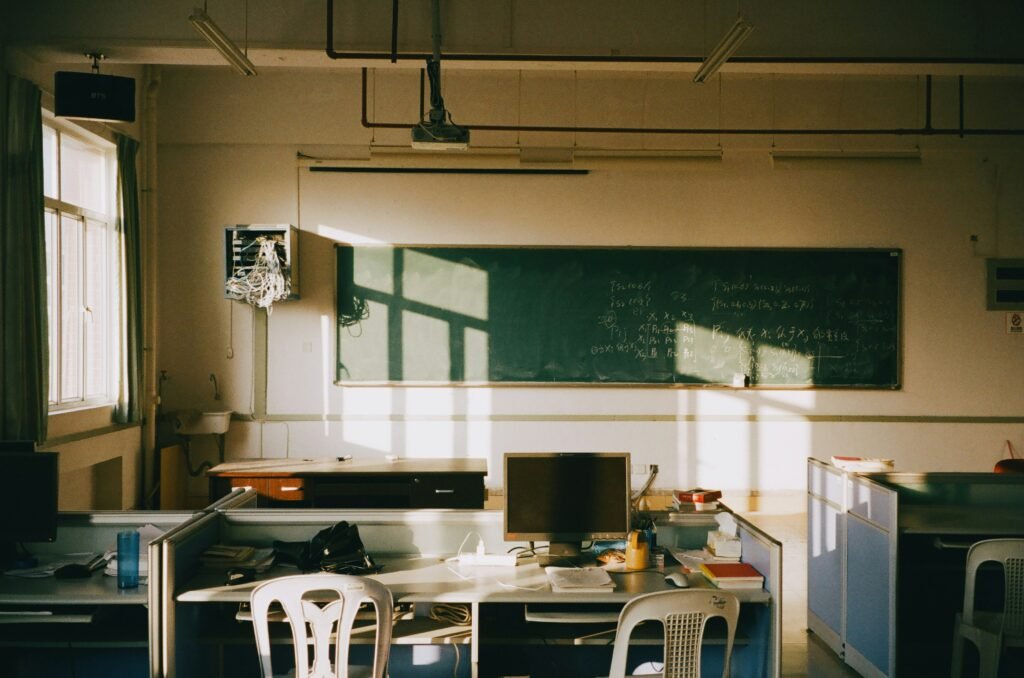 Classroom whiteboard with partially erased math work, shot from an angle